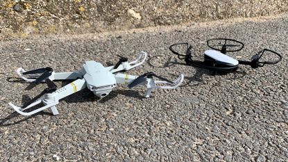 Potensic Elfin and Eachine E58 Pro drones next to each other on the ground