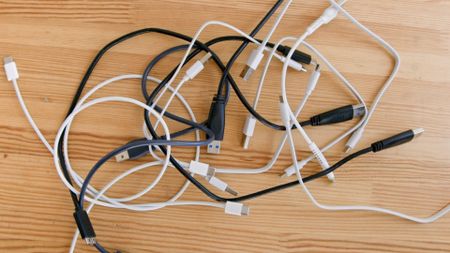 A selection of USB cables on a wooden table