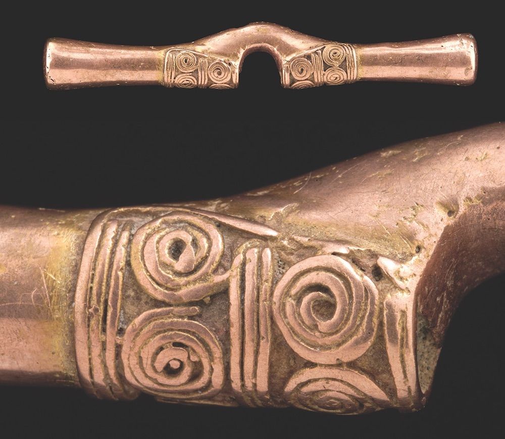 A cast nose ornament, once gold on the surface but purposely polished to be pink.