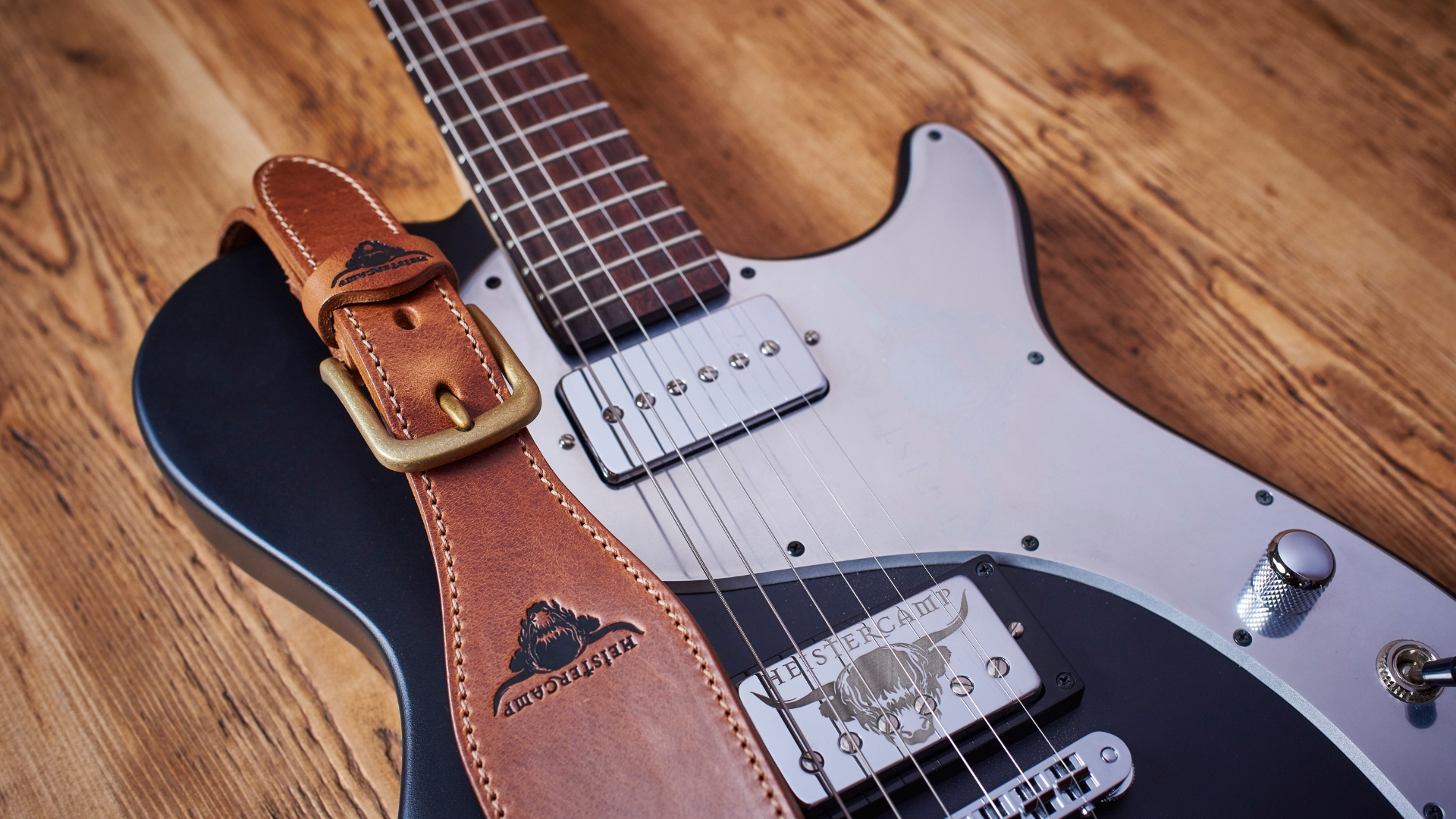A leather guitar strap on an electric guitar