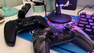 The DualSense Charging Station alongside two PS5 controllers.
