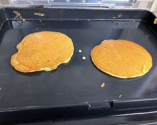 Two pancakes made using Jiffy cornmeal mix on Ninja Sizzle Indoor Grill appliance