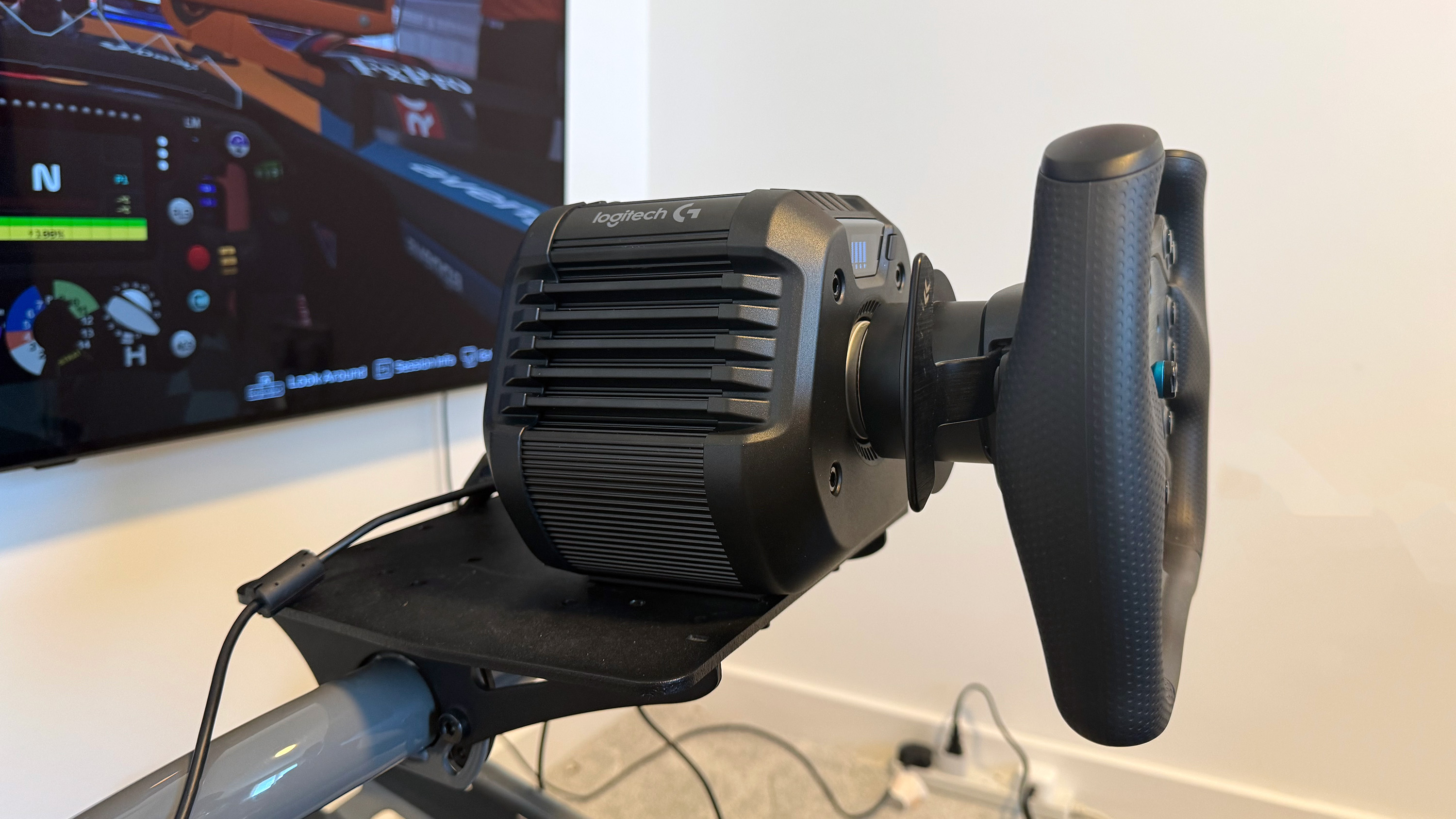 The Logitech G RS50 wheelbase and wheel hub from the side
