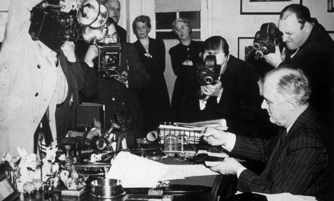 President Roosevelt signs the Lend-Lease Bill at the White House in 1941.