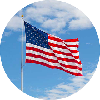 Image of the USA flag with clouds and sky in the background