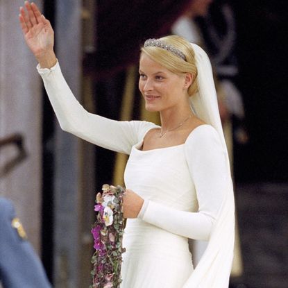 Crown Princess Mette-Marit wearing her wedding gown and waving