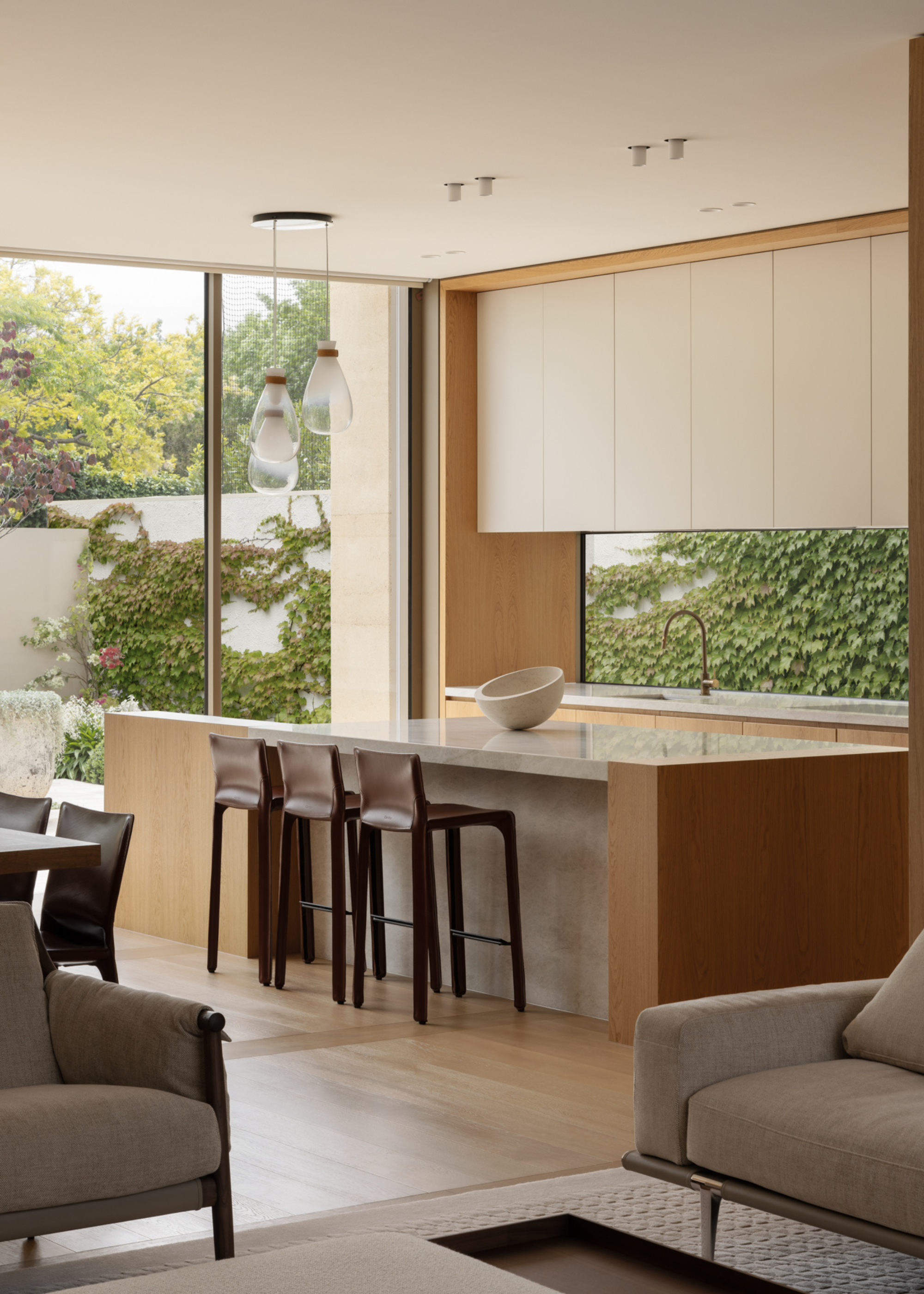 A kitchen with airy windows, and doors to a balcony space