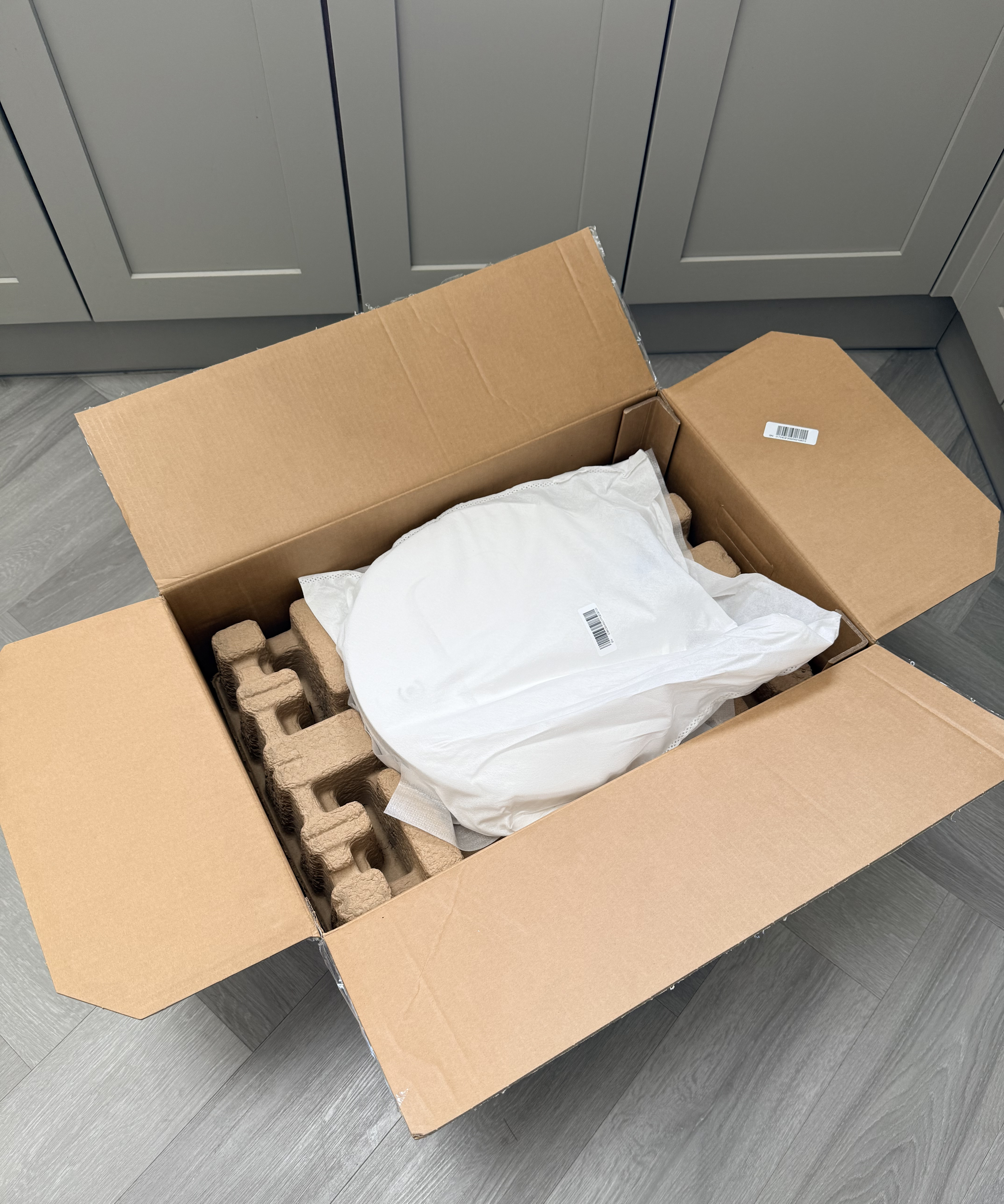 Open Ecovacs Deebot T50 Pro Omni retail box showing the robot vacuum and accessories packed inside