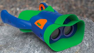 Educational Insights binoculars for kids on a stony backdrop.