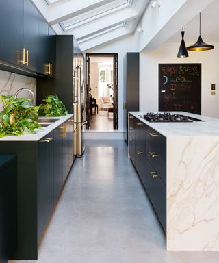 can you fit an island in a galley kitchen, black and marble galley kitchen in extension, skylights, view to living room, chalkboard, pendant light, grey flooring, hob in island
