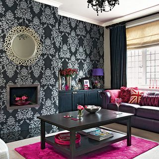 living room with damask wallpaper and table