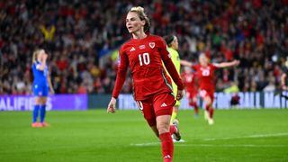 Jess Fishlock celebrates scoring a goal for Wales