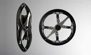 Black wheels photographed against a grey background
