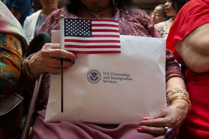 A new citizen holds an American flag.