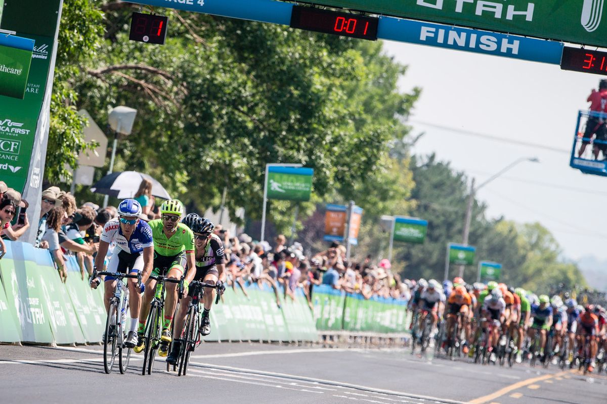 The breakaway comes under the finish line gantry during the final laps