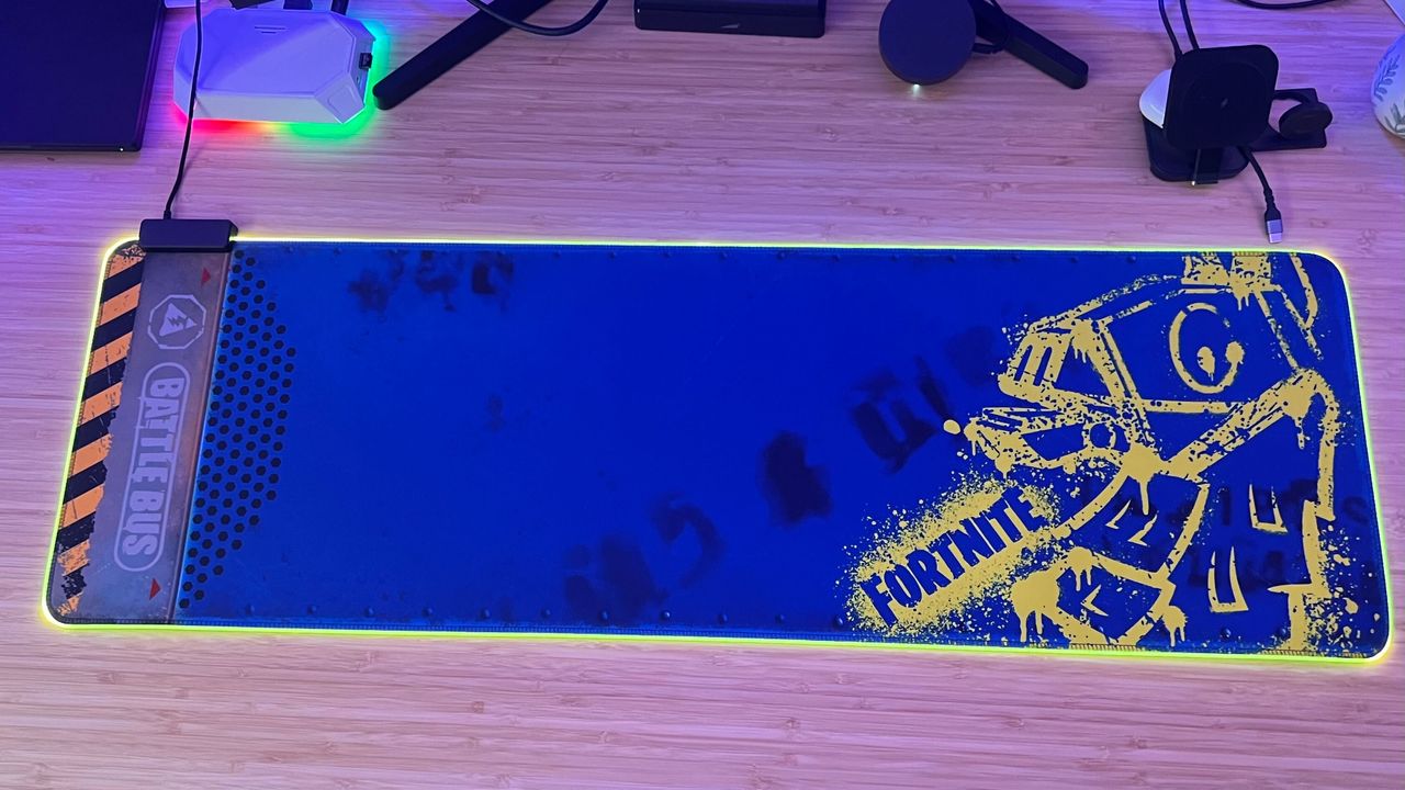Razer Goliathus Extended Chroma Fortnite Edition mouse pad on a wooden desk with RGB on