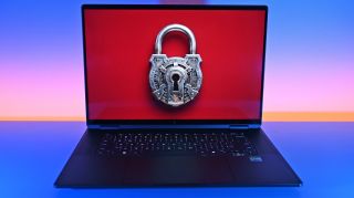 A laptop displays a large, ornate silver padlock on a red screen, symbolizing cybersecurity and data protection against a vivid blue and pink backdrop.