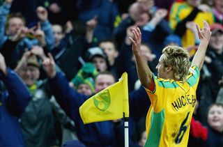 Darren Huckerby of Norwich celebrates his goal with the crowd during the Nationwide Division One match between Norwich City and Ipswich Town at Carrow Road on March 7, 2004 in Norwich, England