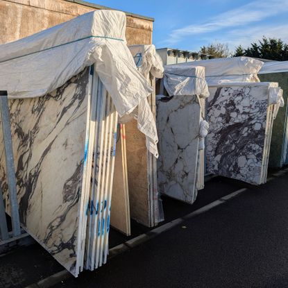 Large slabs of stone outside in warehouse yard