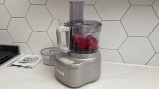 The Cuisinart Easy Prep Pro FP8 on a kitchen countertop ready to grind beef