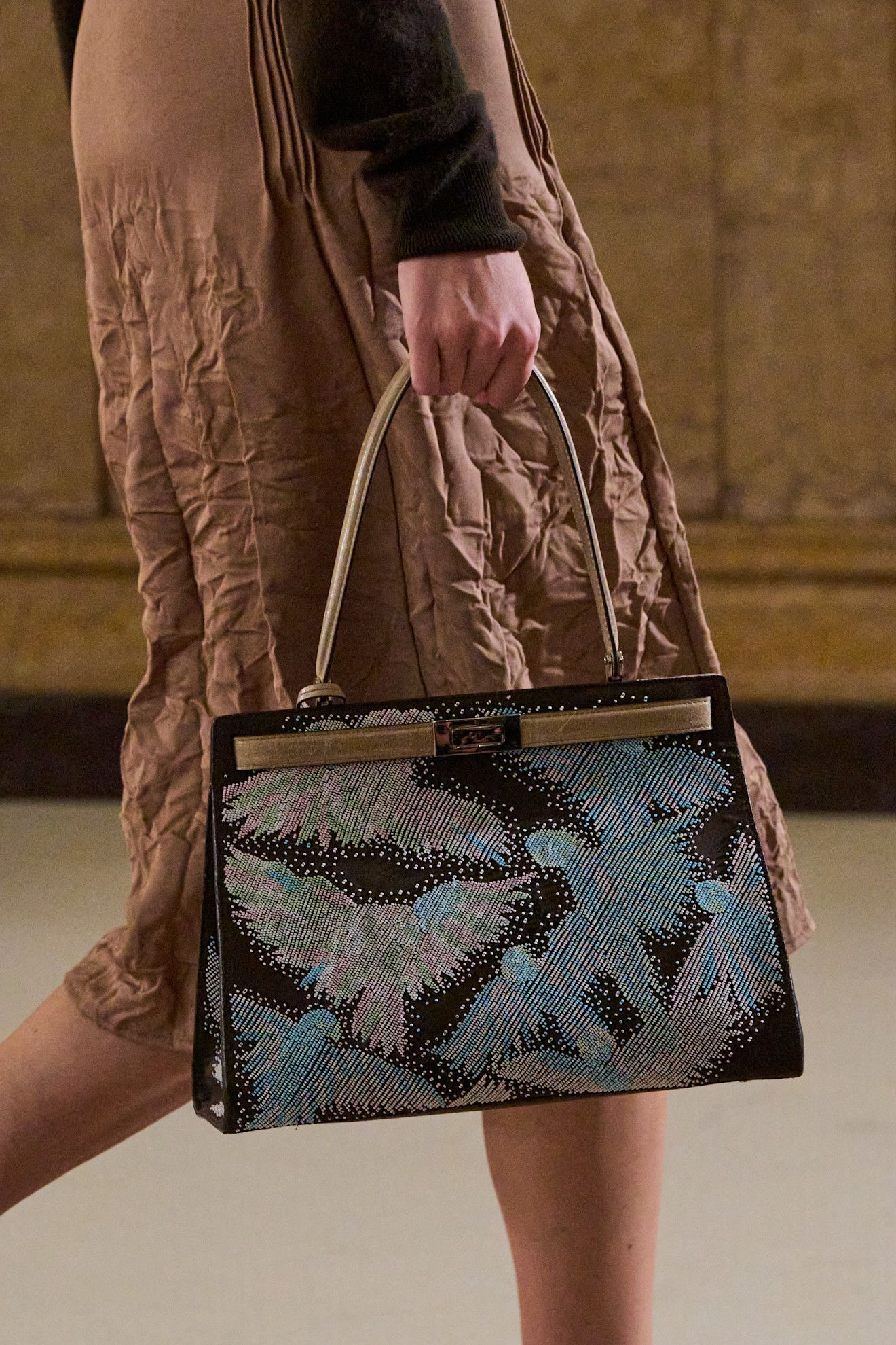 Model carrying a Tory Burch bag.
