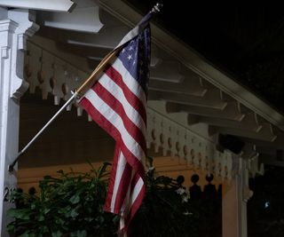 US flag on a porch at night