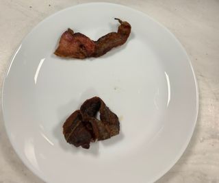 Air fried bacon on a plate.