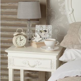 Shabby chic vintage style bedside table, distressed wood, alarm clock, table lamp, French damask patterned wallpaper, IH 04/2014