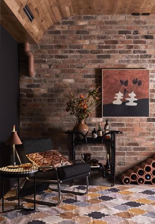 A living room with exposed brick wall