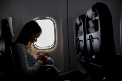 air hostess breastfeeds crying baby