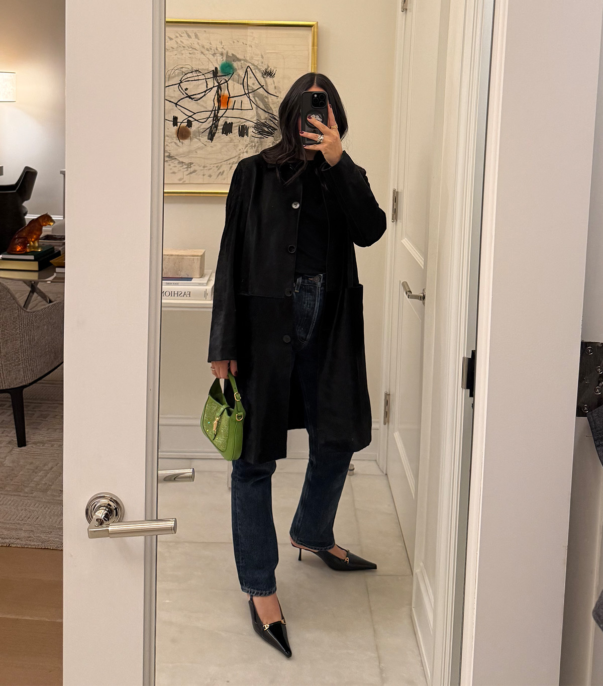 @nicoleakhtarzad taking a mirror selfie wearing a winter outfit.