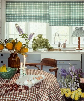 blue kitchen with green gingham window blinds filled fresh flowers, with a round table