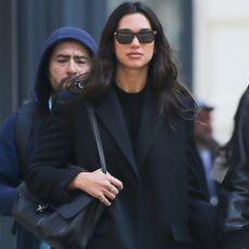 Dua Lipa livened up her all-black street style look with the Chanel maxi flap bag