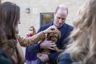 Britain's Prince William, Duke of Cambridge and Catherine, Duchess of Cambridge meet new therapy puppy Alfie, an apricot cockapoo, funded through hospital charity ELHT&me using a grant from NHS Charities Together, during a visit to meet NHS staff and patients at Clitheroe Community Hospital and hear about their experiences during the Covid-19 pandemic