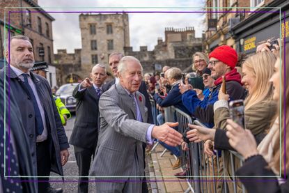 King Charles III meeting fans with security behind him
