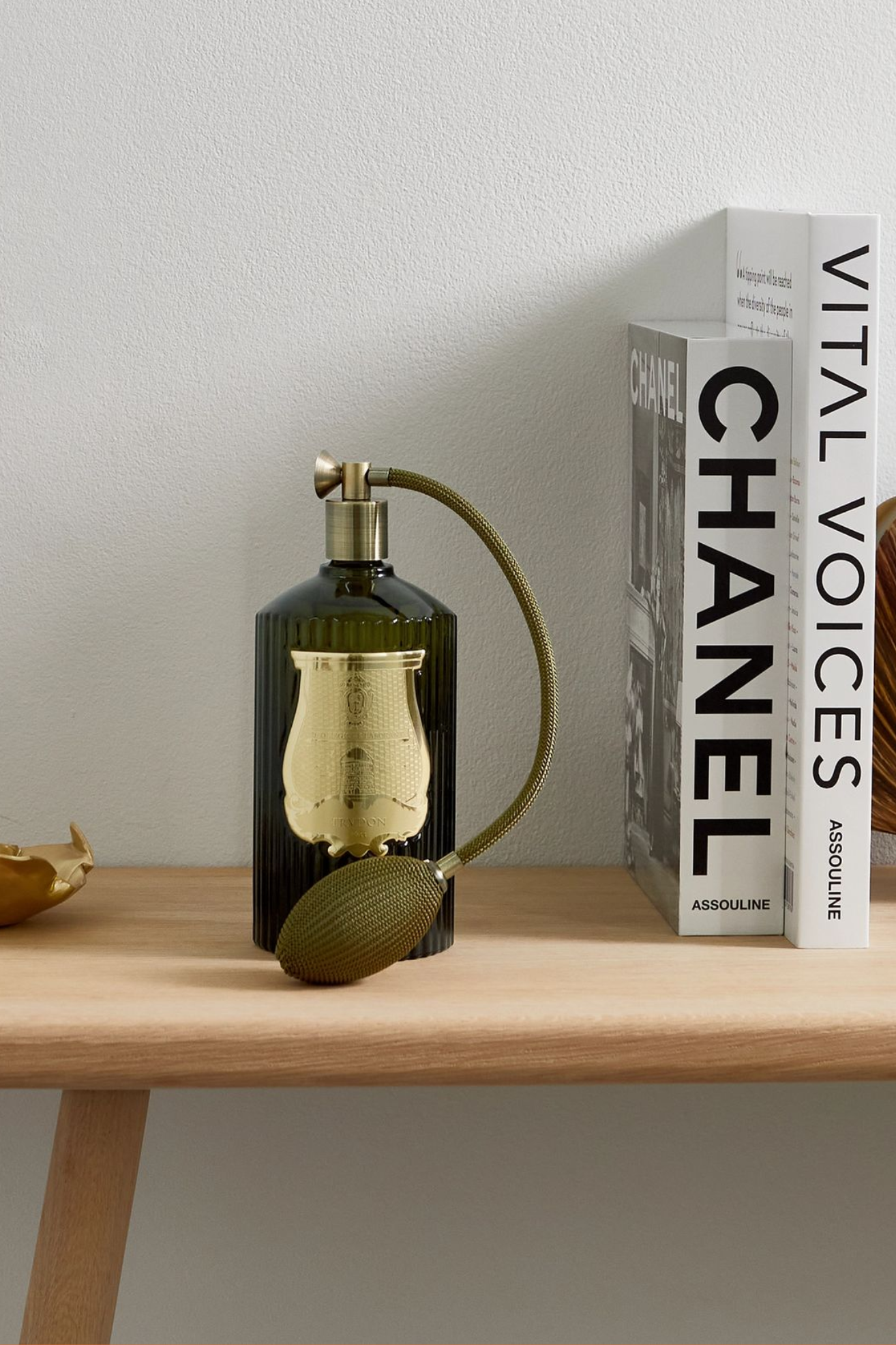 A vintage perfume bottle room spray on a wood side table