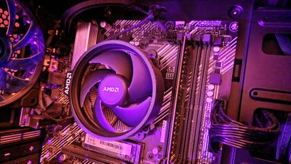 AMD Ryzen 5 3500 on a motherboard with an AMD CPU fan on top of it