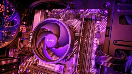 AMD Ryzen 5 3500 on a motherboard with an AMD CPU fan on top of it