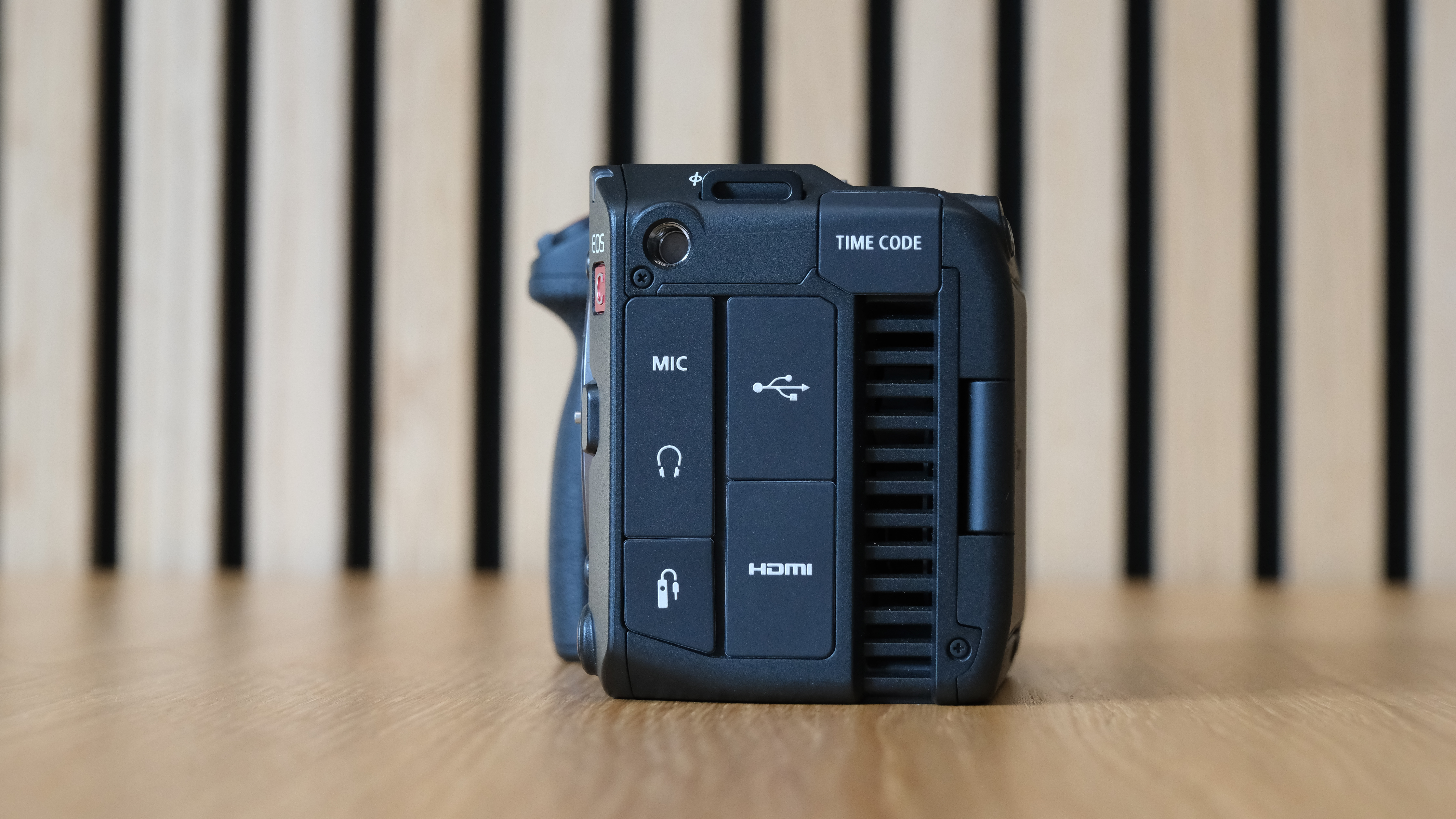Canon EOS C50 against a striped wooden background