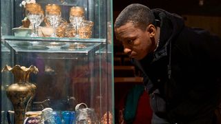 A guest at Tara Theatre looking into a glass cabinet