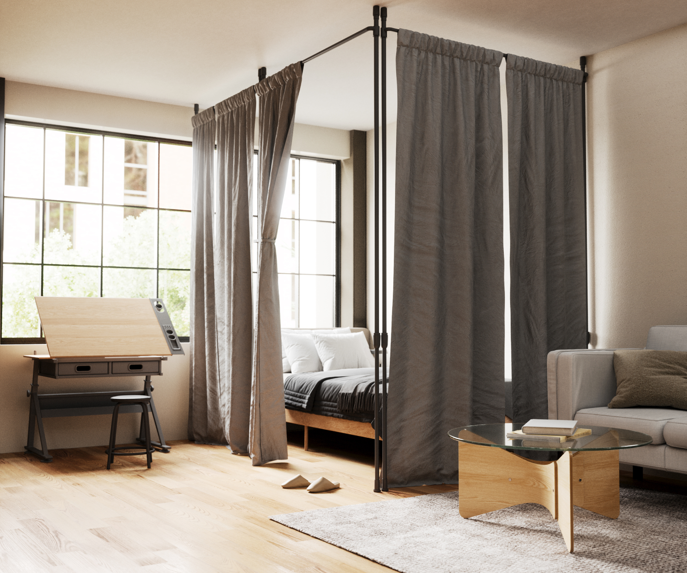 studio space with bedroom zoned using floor to ceiling poles and curtain rods, desk to one side and sofa at the end of the bed