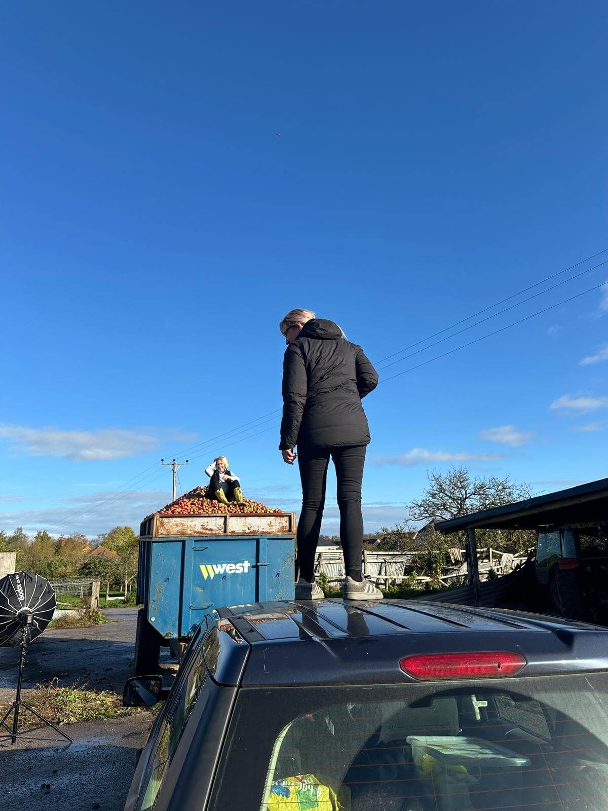 Woman stood on car roof.