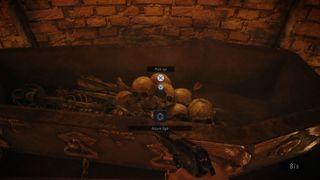 A player interacts with a pile of skulls