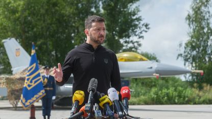 Ukraine&#039;s President Volodymyr Zelenskyy stands in front of the first General Dynamics F-16 Fighting Falcon received by Ukraine as he congratulates Ukrainian military on the Day of Ukrainian Air Force on 4 August 2024