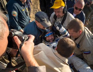 Expedition 36 Commander Helped Out of Soyuz Capsule