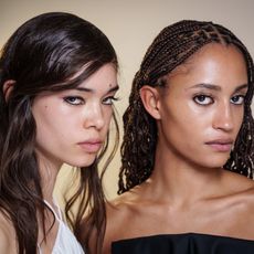 two young women with glowing skin and dark hair