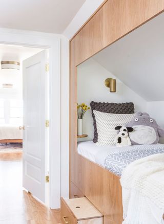 Bed built into eaves in child's bedroom