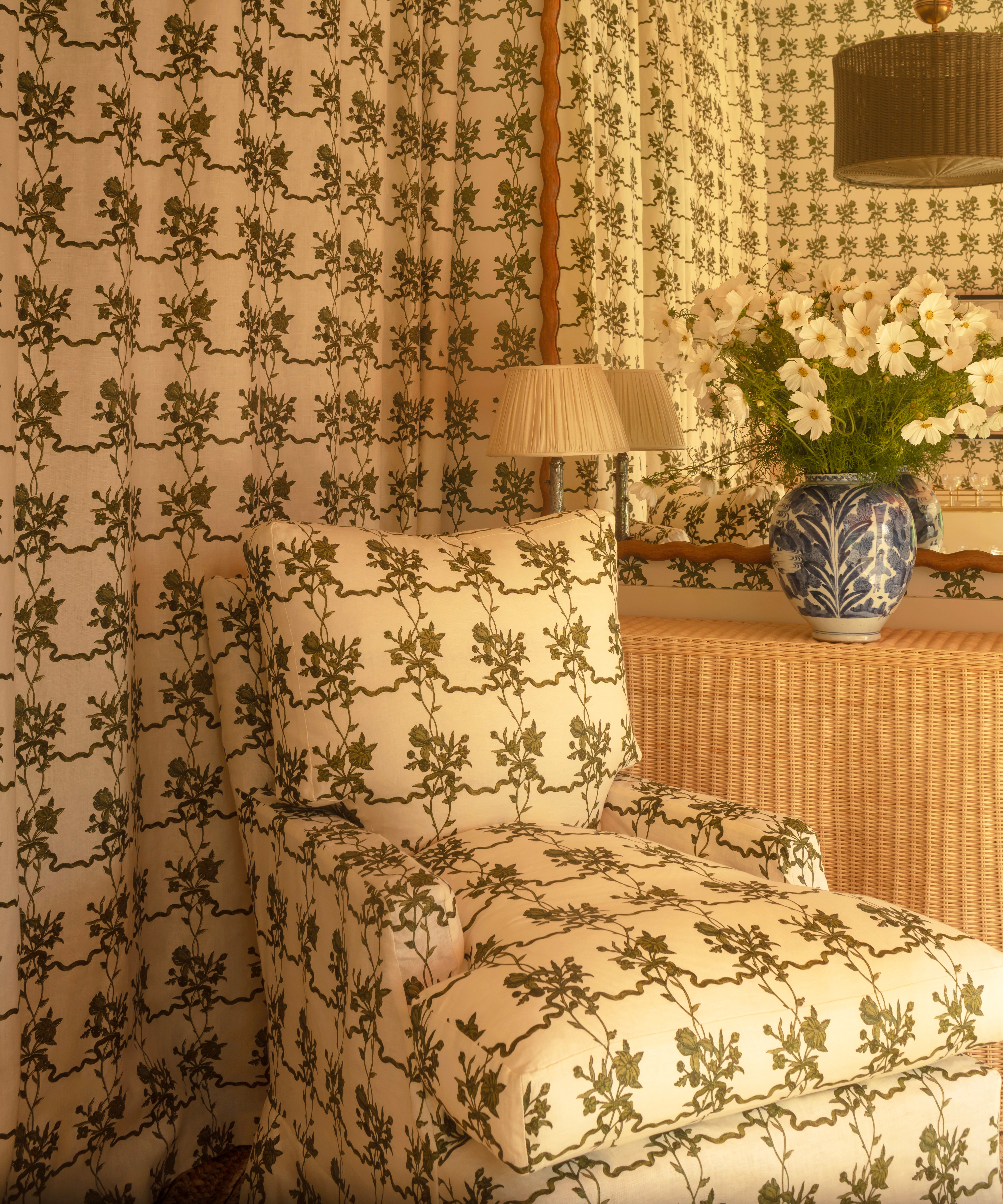 patterned armchair in front of patterned wallpaper in the same print