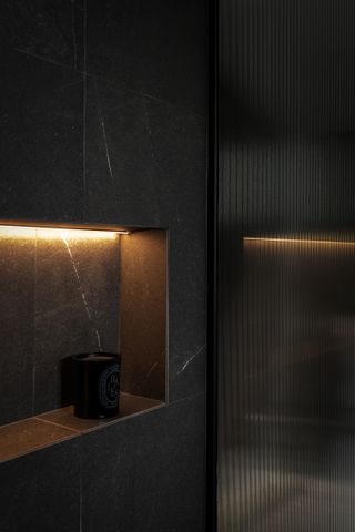 A bathroom niche lit up with LED lights