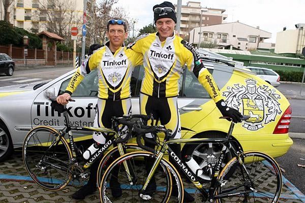 Hamilton and Tinkov pose in front of the team car.